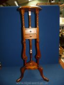 A pot/plant stand with two drawer shelf.