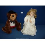 A bear Doorstop together with a praying doll.