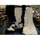 A box of Victorian nightgowns, black cap, gloves, feather boa etc.