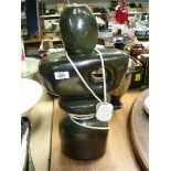 A large green table lamp with abstract design of a hole in the heart, 20'' tall,