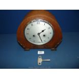 An Enfield mantle Clock with key, 9" tall.