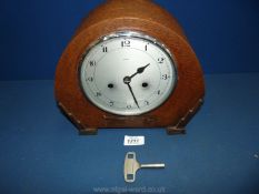 An Enfield mantle Clock with key, 9" tall.