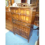 An Old Charm/Priory Oak style Oak Drinks Cabinet/Cupboard having a full width drawer,