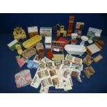A box of doll's house bathroom items including sinks, toilets, plastic sinks, etc.
