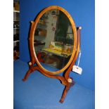 An elegant oval dressing mirror