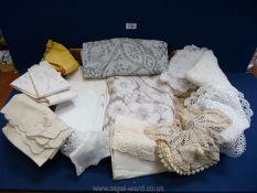 A box containing a selection of tablecloths and miscellaneous crocheted/lace items, serviettes,