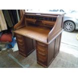 A double pedestal/scroll top, roll top Oak Desk having a nicely fitted interior,