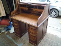 A double pedestal/scroll top, roll top Oak Desk having a nicely fitted interior,