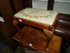 A dressing table stool with embroidered seat and cabriole legs.