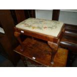 A dressing table stool with embroidered seat and cabriole legs.