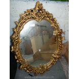 A gilt type finished framed shaped wall hanging Mirror,