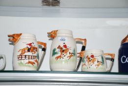 A trio of graduated Portland Pottery hunting Jugs, marked 'England PPC' to base.