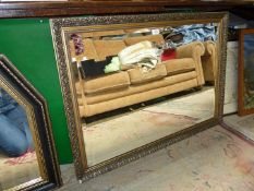 A large gilt framed bevel plated mirror,