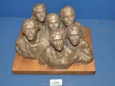A bronzed effect sculpture of six figures on wooden plinth, marked to rear 2/60 'Audience'.