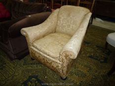 A circa 1900 Armchair of elegant form upholstered in pale gold coloured satin like shadow pattern