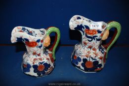 Two reproduction Imari style Ironstone jugs. 8 1/2" and 7" tall.