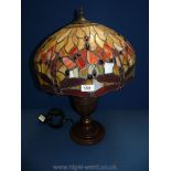 A large Tiffany style lamp with bronzed effect base and dragonfly to the rim, 22" tall.