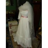 A Wedding Dress with three quarter puff sleeves, pink bows and roses, size 10/12, with veil.