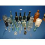 A box of old empty bottles including green glass marked Hitchman & Co.