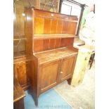 A dark Oak Cottage Dresser having opposing doors to the base and with two tier integral plate rack