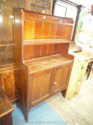 A dark Oak Cottage Dresser having opposing doors to the base and with two tier integral plate rack