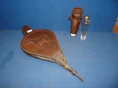 A glass and white metal hip flask in leather case and fire bellows with carved horse.