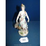 A 19th century Royal Vienna figure of a Juno accompanied by her peacock; shield mark in blue,