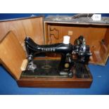 A cased Singer hand sewing machine,