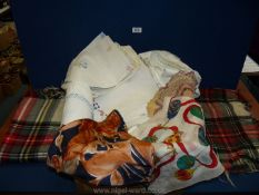 A quantity of linen including tablecloths, napkins, two tartan travel rugs, scarves, etc.