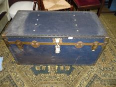 A large dark blue Trunk with brass corners and studs, 39 1/2'' long x 20'' deep x 19 3/4'' wide.