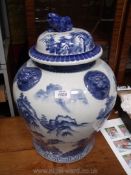 A Chinese lion pot and a very large blue and white ginger jar with lid, 21" tall.