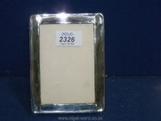 A silver photograph frame, Birmingham 1921, maker B&M, 6'' x 4''.