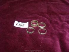 Four silver band style rings.