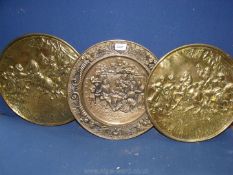 Three brass wall plaques.