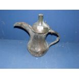 An antique copper Arab dallah, coffee pot, with old repairs and evidence of much use.