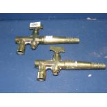 Two Victorian brass barrel taps.