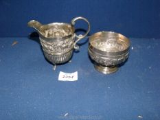 A small Indian white metal embossed jug and bowl
