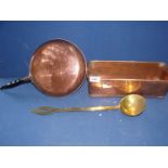 A copper frying pan and trough and a brass ladle.