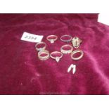 A quantity of silver rings, some with stones and a silver charm of a pair of shoes.