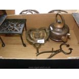 Two trivets, a copper kettle and a pair of sugar nippers/coal tongs.
