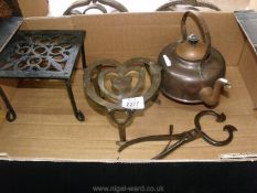 Two trivets, a copper kettle and a pair of sugar nippers/coal tongs.