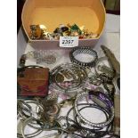A quantity of costume jewellery and a box of brooches and studs.
