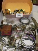 A quantity of costume jewellery and a box of brooches and studs.