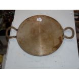 A cast iron bake-stone 14'' diameter.