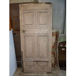 A heavy painted, possibly Oak door with panelled details, 36 1/2'' wide x 82 1/2'' high x 2'' thick.