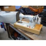 Cased Frister & Rossman model 25 hand operated sewing machine.