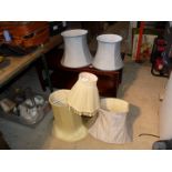 Quantity of various lamp shades.