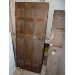 A heavy 12 panel, possibly Oak door, 35 1/2'' wide x 83 1/2'' high x 2'' thick.