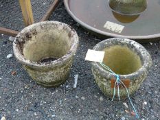 Two round concrete garden planters