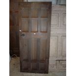 A heavy 12 panel, possibly Oak door 35 1/2'' wide x 83 1/2'' high x 2'' thick.